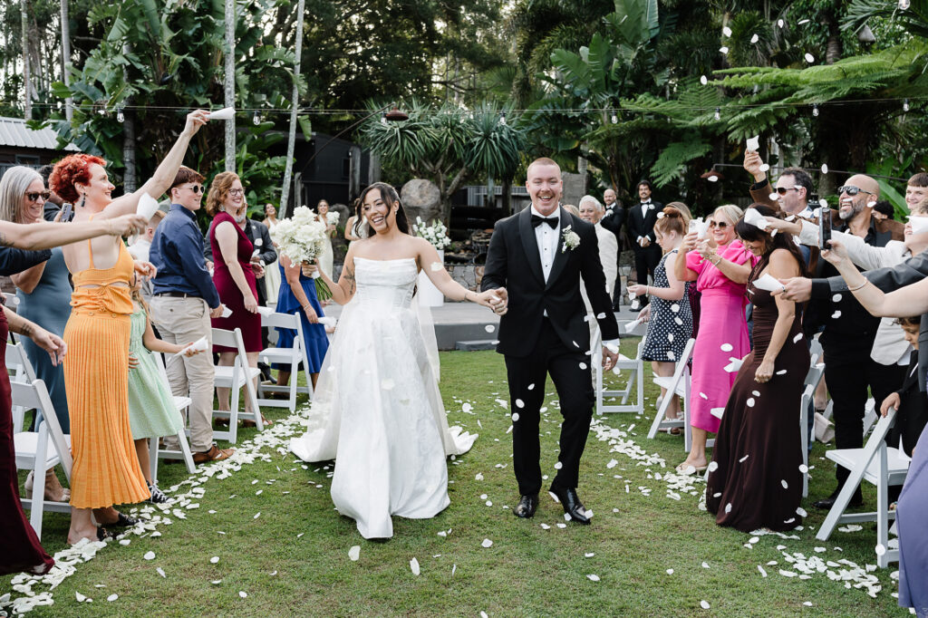 Backyard Wedding Ceremony | Sunshine Coast Wedding Photography Bride and groom walking back up the aisle after their backyard wedding ceremony on the Sunshine Coast, captured by a Sunshine Coast wedding photographer & videographer.
