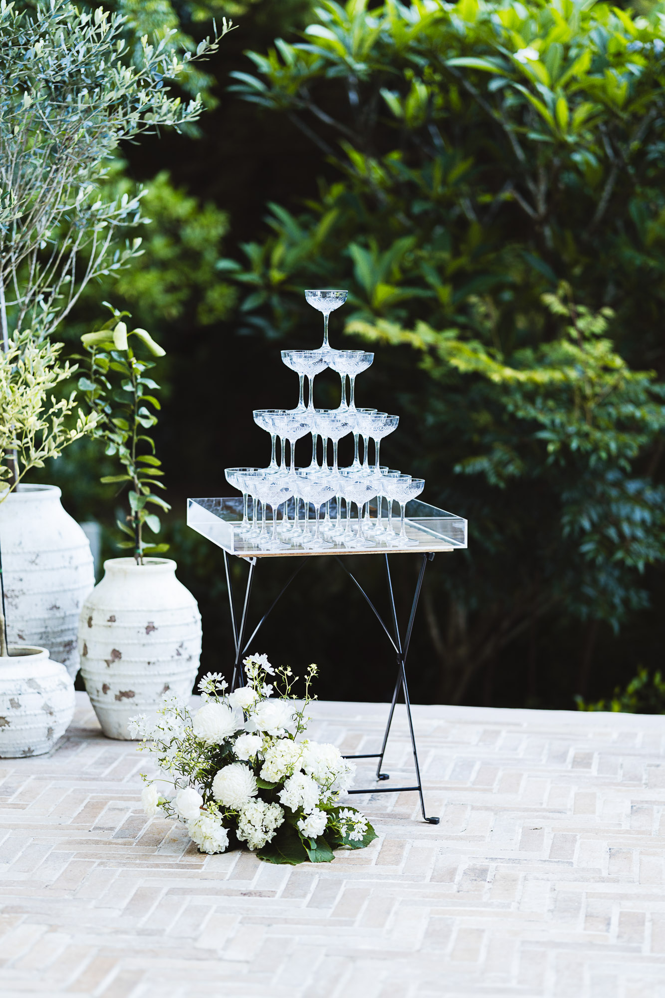 Elegant champagne tower reception at The Rustic Olive Estate in Maleny, photographed by a Sunshine Coast wedding photographer and videographer during a timeless hinterland wedding celebration.
