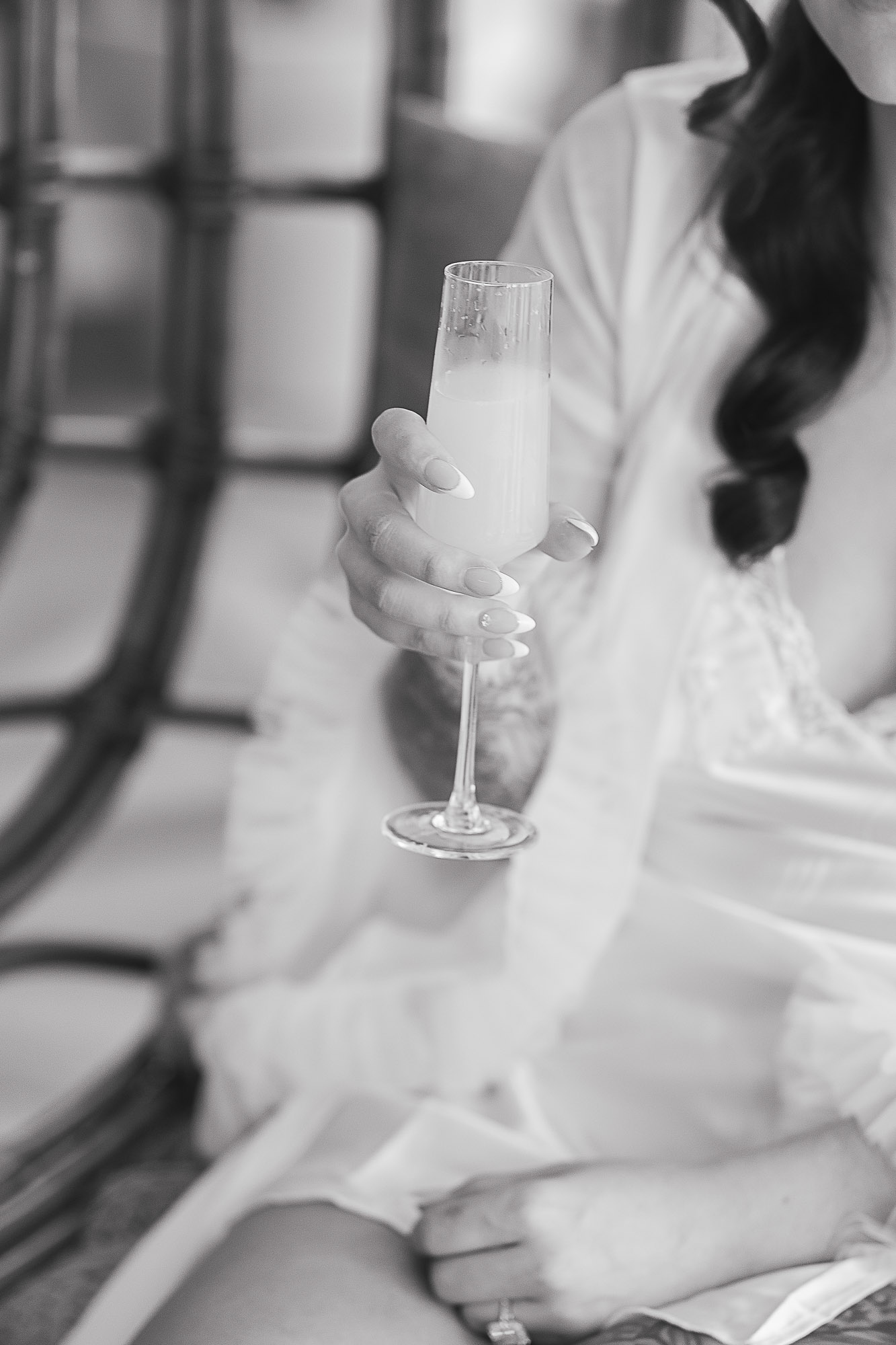 Bride enjoying a champagne toast while getting ready for her elopement at The Lakehouse Folk in Montville, photographed by a Sunshine Coast elopement photographer & videographer