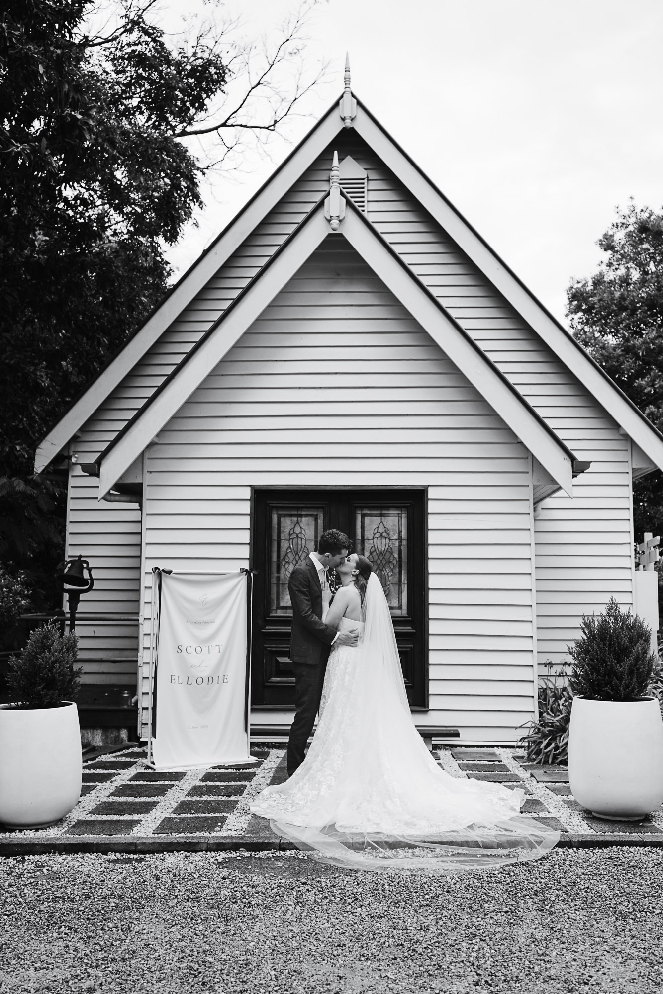 The Little White Chapel Maleny Wedding Portraits | Sunshine Coast Wedding Photographer Bride and groom sharing a romantic portrait outside The Little White Chapel in Maleny after their wedding ceremony.