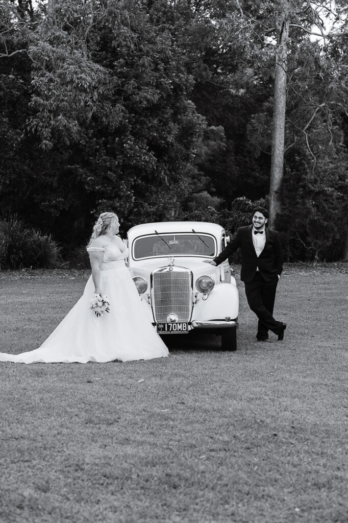 Classic Car Wedding Portraits | Samsonvale Hall Wedding Photographer Bride and groom sharing romantic wedding portraits with their classic car outside Samsonvale Hall in North-West Brisbane.