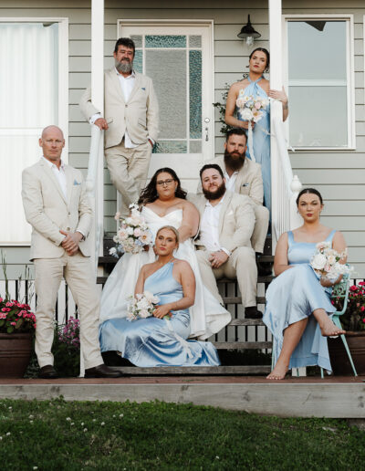 Burgess Cottages Maleny wedding party portrait on a staircase at blue hour, captured by a Sunshine Coast wedding photographer and videographer.