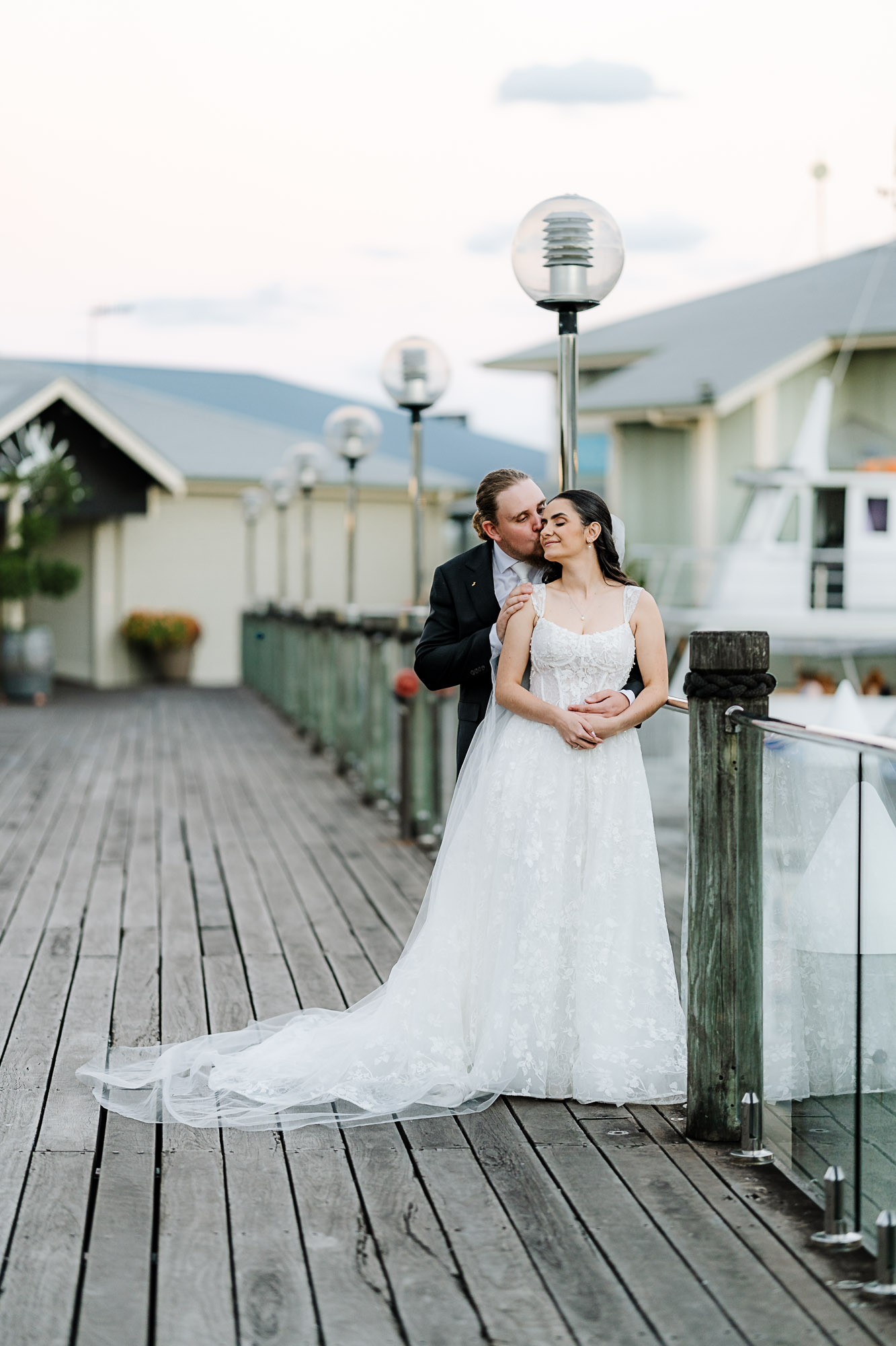 Noosa Marina Wedding Portrait | Sunshine Coast Wedding Photography Newlywed couple sharing a romantic embrace at Noosa Marina before their Sunshine Coast wedding receptio