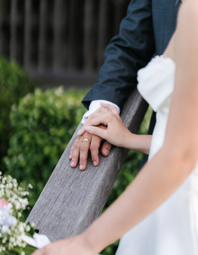 Bride and groom holding hands during their wedding day at Yandina Station, captured by a Sunshine Coast wedding photographer.