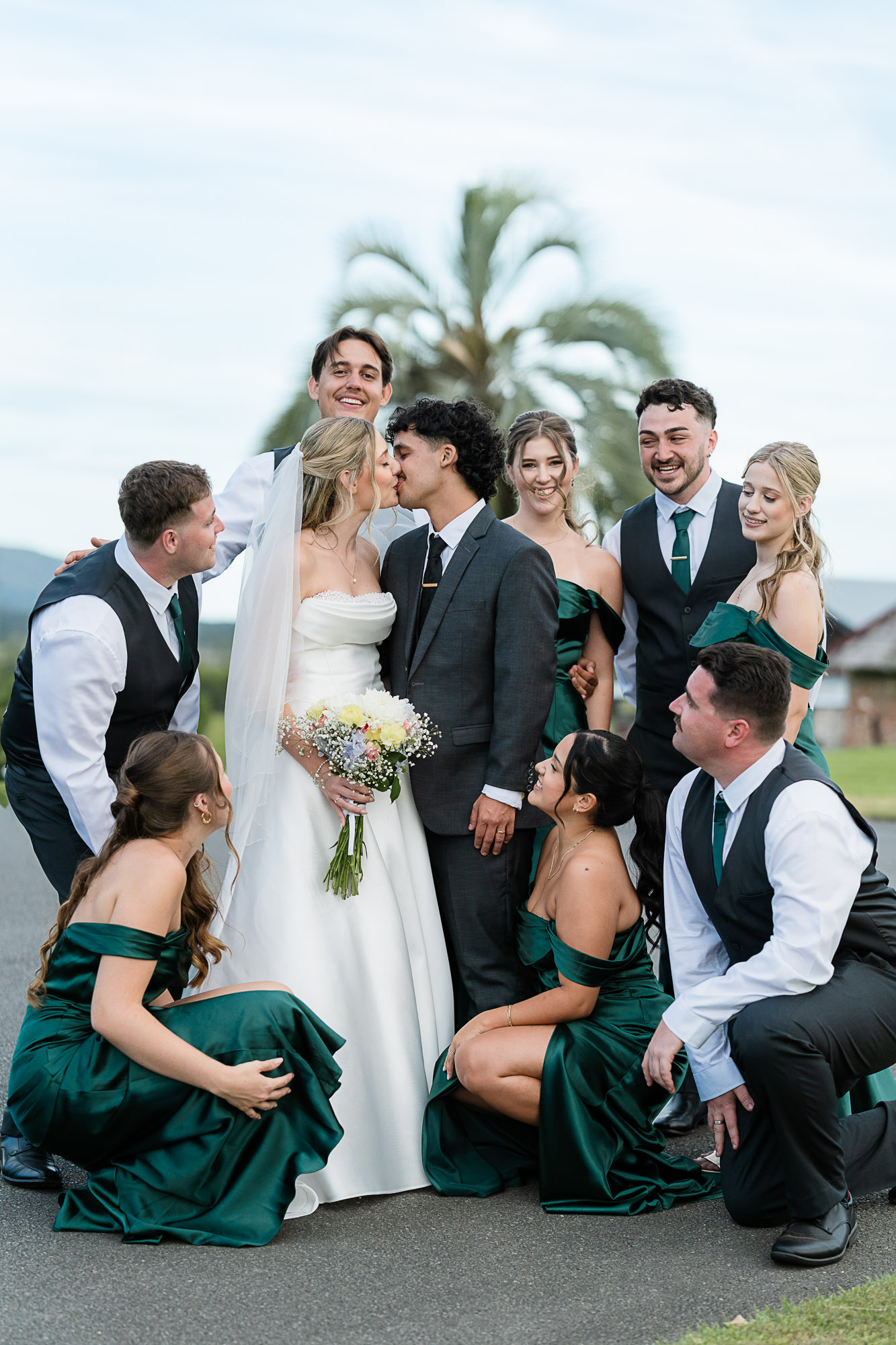 Fun Wedding Party Portraits at Yandina Station Wedding party having fun and laughing together during portrait hour at Yandina Station, captured by a Noosa and Sunshine Coast wedding photographer and videographer.